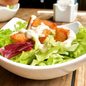 Delicious salad with crispy tofu and creamy dressing, perfect for a healthy meal.