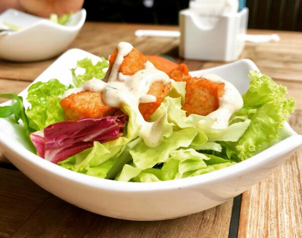 Delicious salad with crispy tofu and creamy dressing, perfect for a healthy meal.